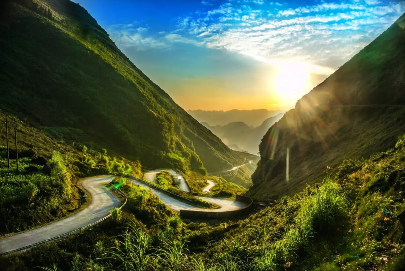 Tham Ma Pass switchbacks on the Ha Giang Loop tour with rice terraces